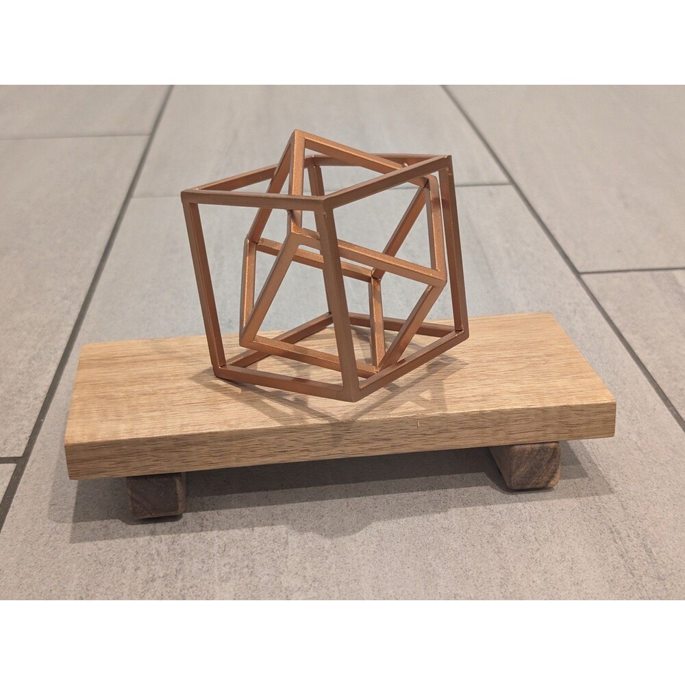 Geometric Metal Cube on Wooden Stand